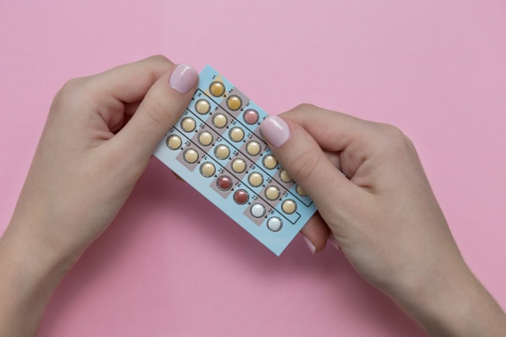 Person holding birth control pack