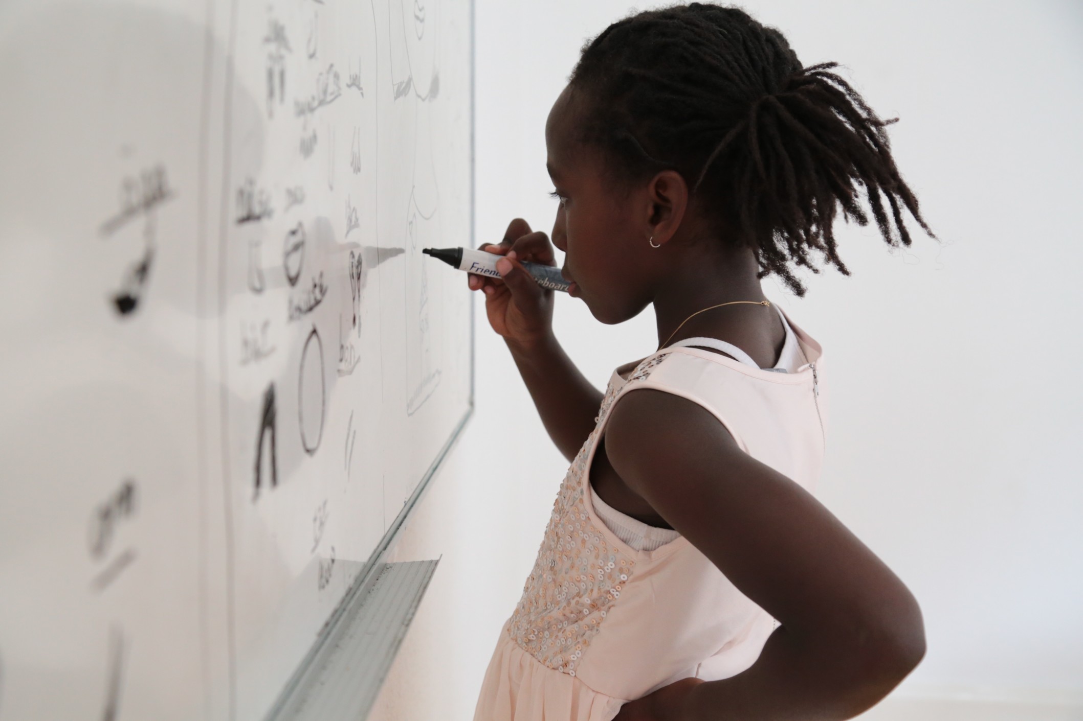 education young black student writing on white board