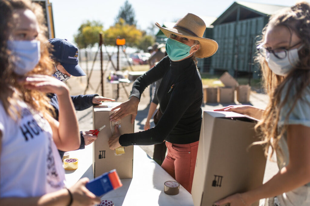 Masked women packing food