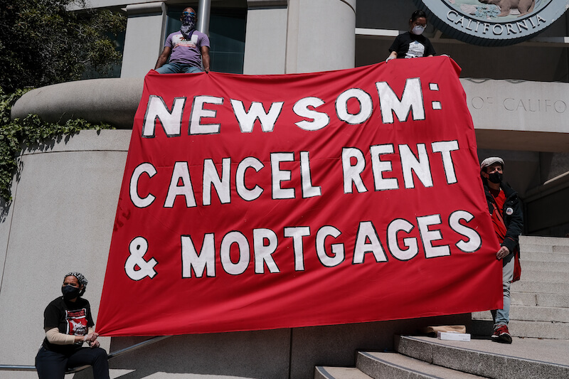 Activists rally for the #CancelRent movement; sign reads: "Newsom cancel rent and mortgages"