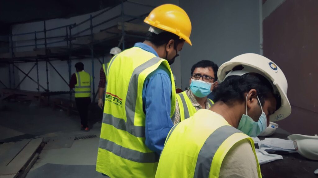 Masked construction workers in conversation