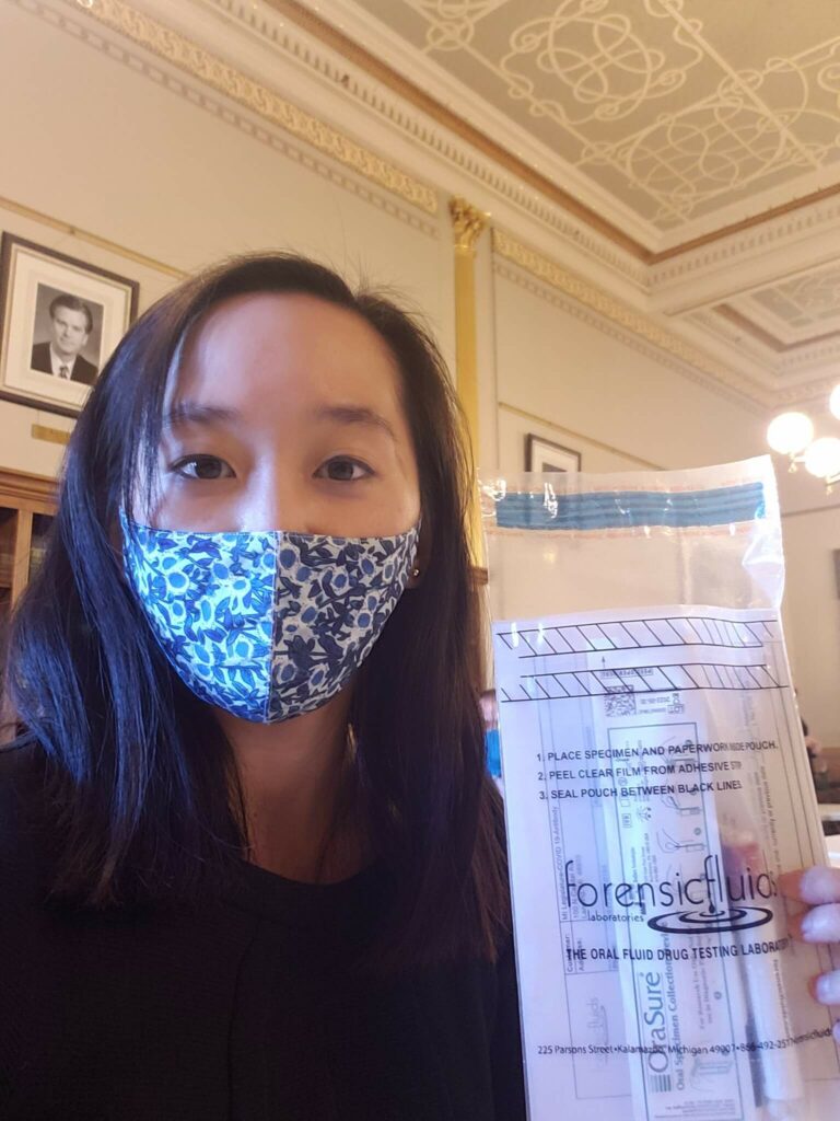 Michigan State Senator Stephanie Chang with COVID-19 test kit in the Michigan State Capitol