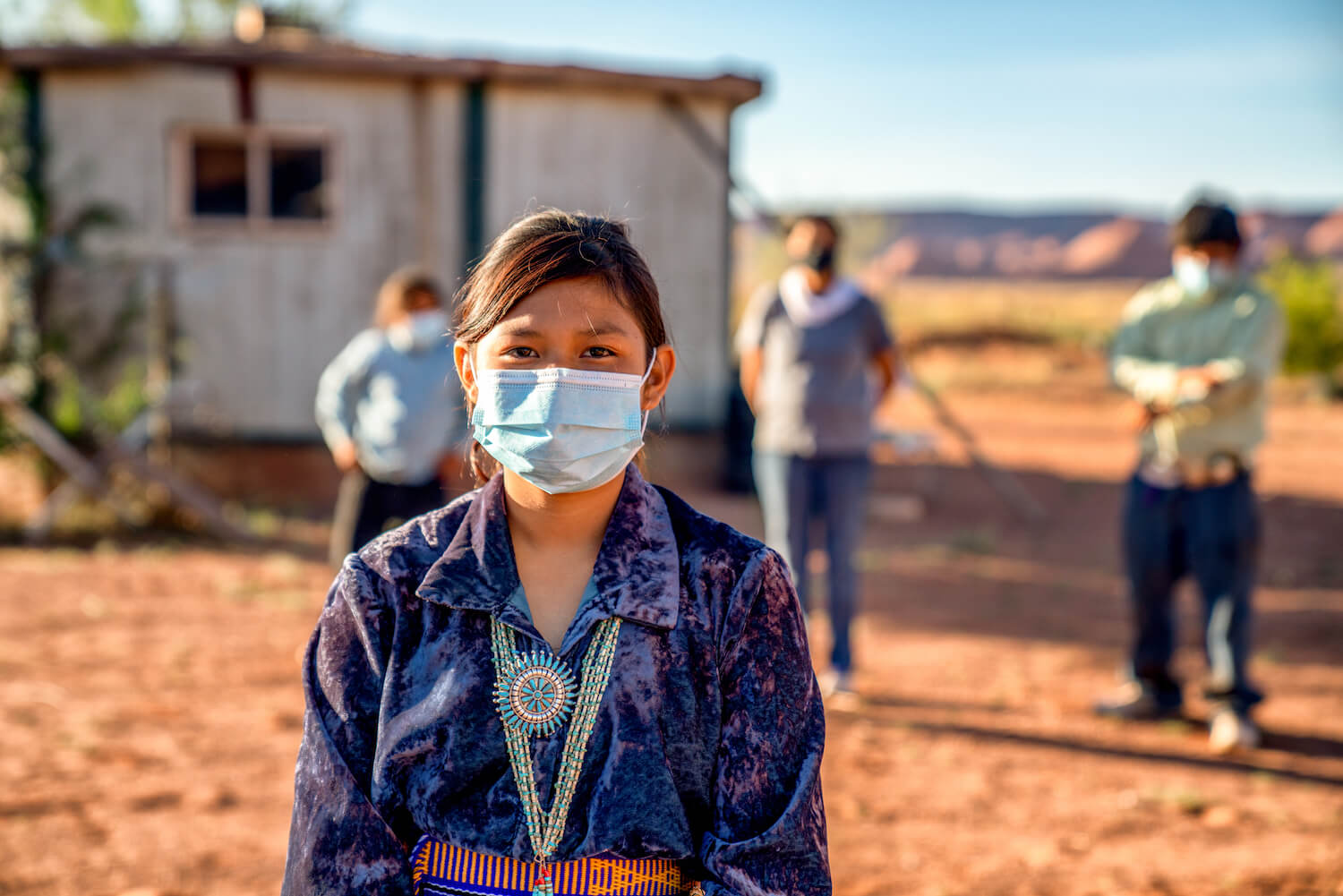 Navajo Family Social Distancing with Covid Masks outside their home in Monument Valley Arizona