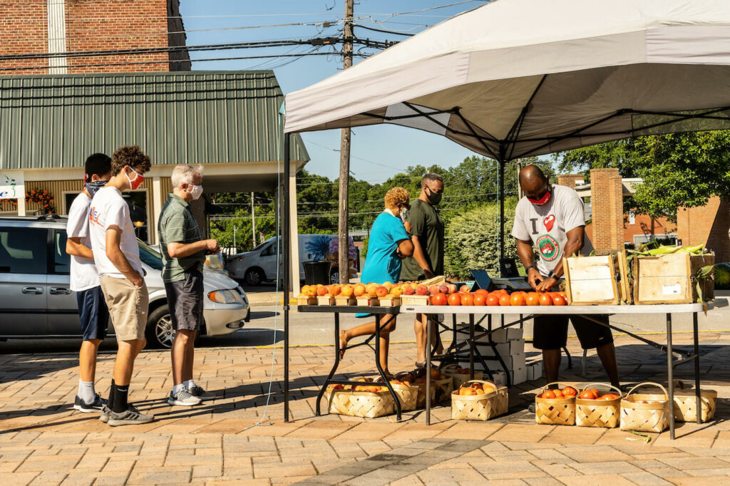 A Vendor is Selling Produce at Farmers Market in Clayton, North Carolina