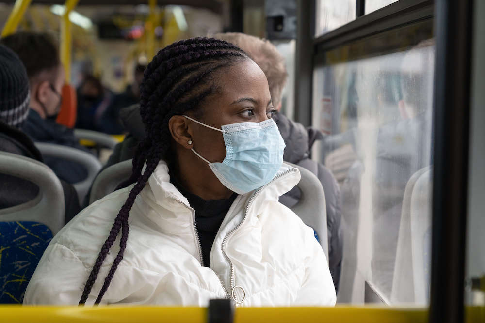 African american woman wearing medical mask while travel in public transport