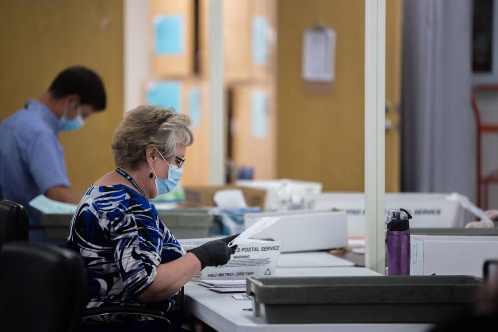 Election poll workers wear masks during the primary election day in Nevada