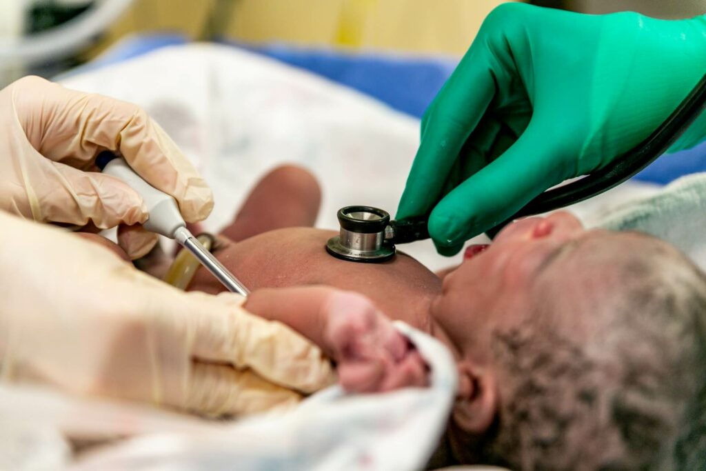 newborn checked by doctors in hospital