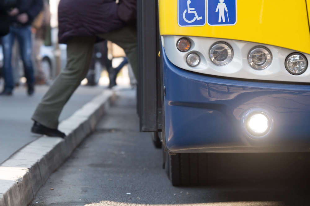 person stepping onto bus