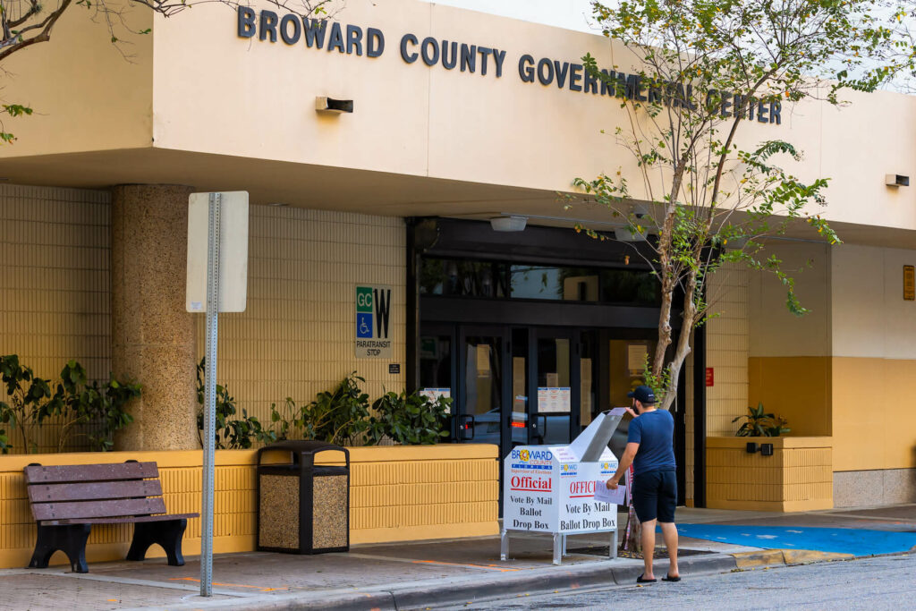 Voter drops ballot in drobpox in Fort Lauderdale Florida in front of Broward County Government Building