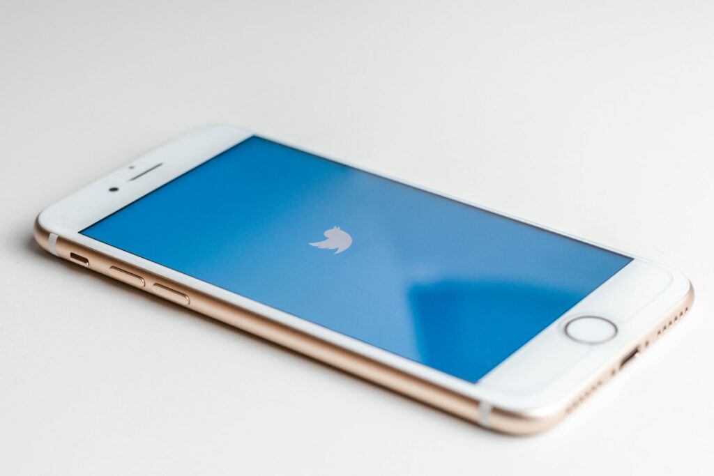 Gold iphone 6s with twitter logo on screen