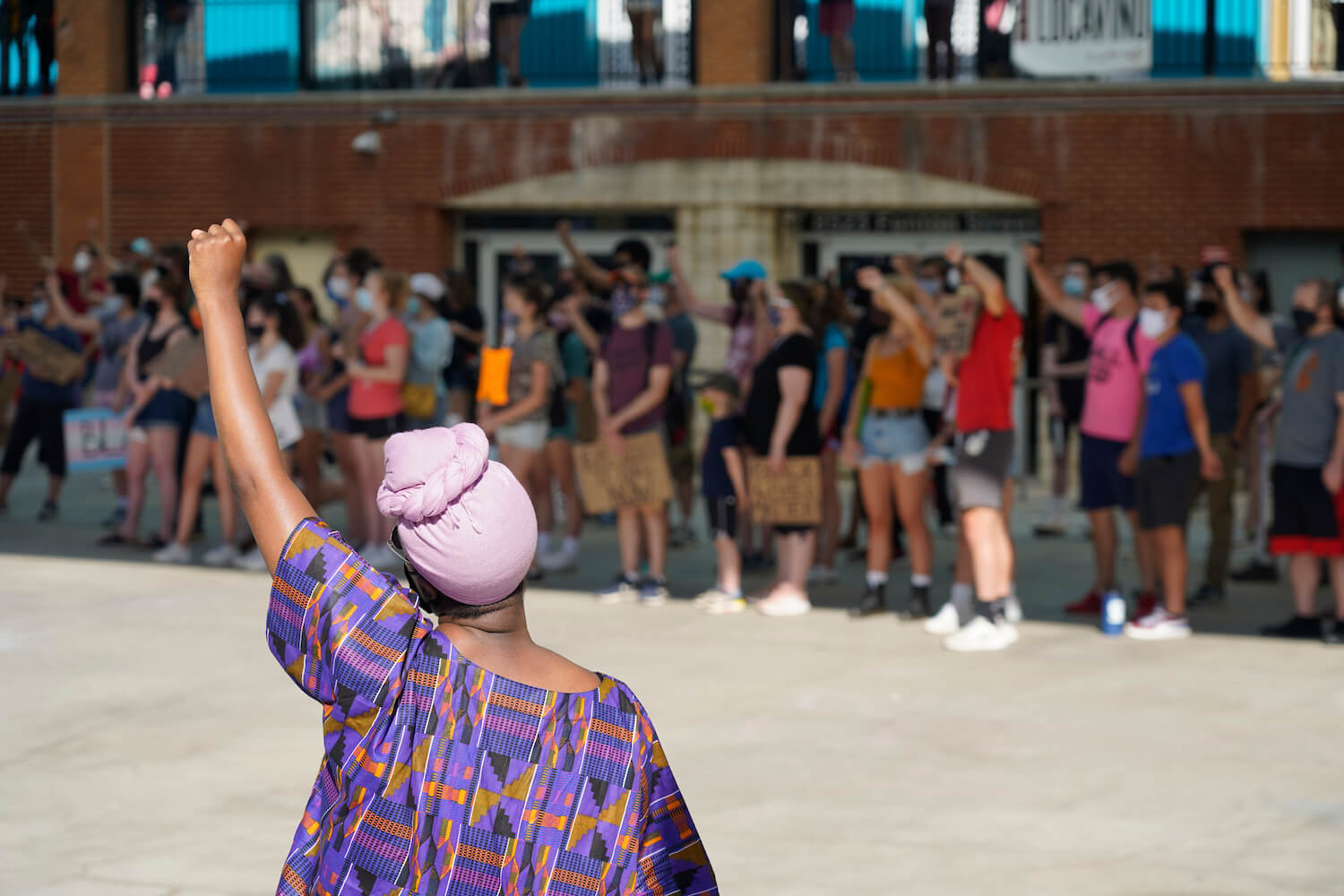 Demonstrators raise their fists during a Black Lives Matter protest on Veteran Plaza in downtown Silver Spring, Maryland