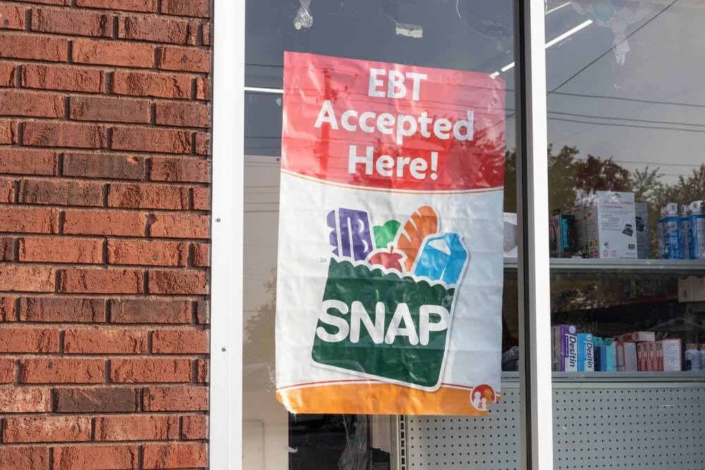 Exterior window of retail store; sign reads, "EBT Accepted here! SNAP"