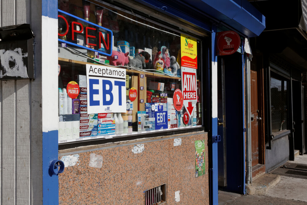 Exterior of convenience store in Philadelphia; signs read "EBT Aceptamos" and "ATM here" Jana Shea / Shutterstock.com